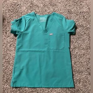 Womens scrub top in surgical green. On pocket. Size small